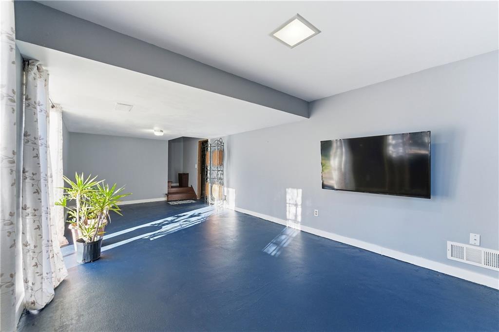 3033 Thrasher Circle Decatur, GA 30032 - Photo 19 of 25 a view of a livingroom with wooden floor and a flat screen tv