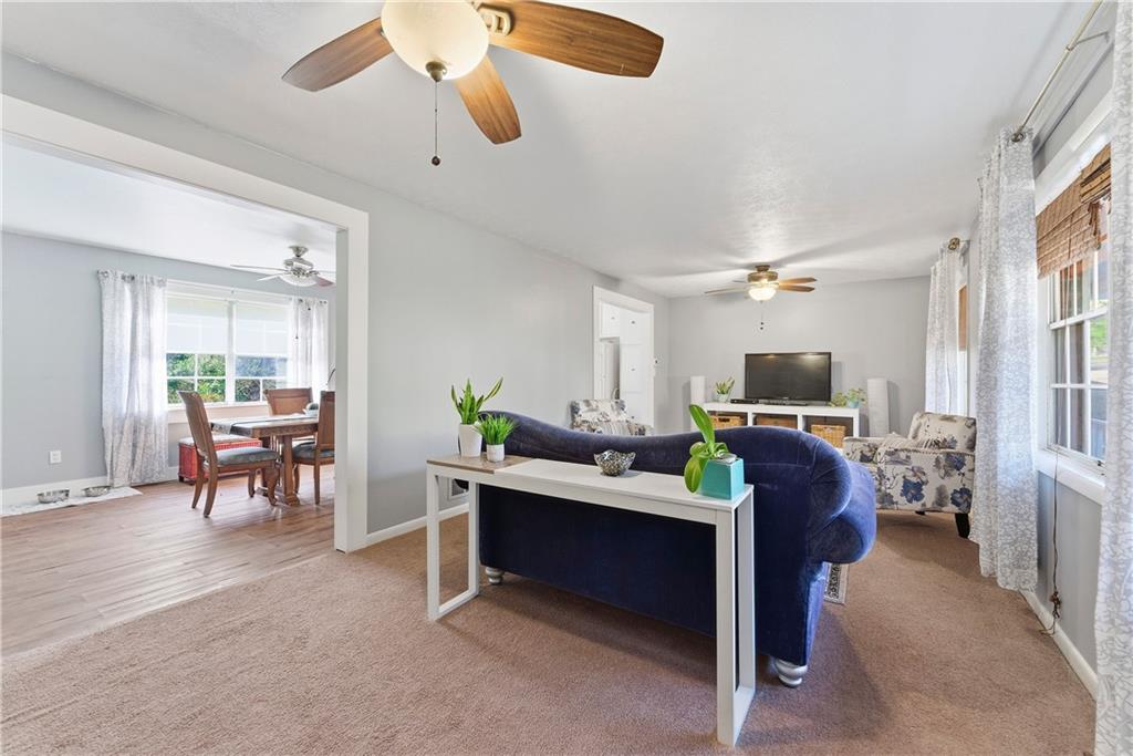 3033 Thrasher Circle Decatur, GA 30032 - Photo 4 of 25 a living room with furniture a dining table and a piano