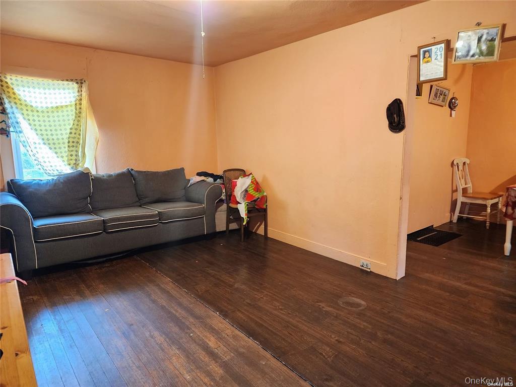 418 Lincoln Street Riverhead, NY 11901 - Photo 2 of 11 a living room with furniture and a wooden floor
