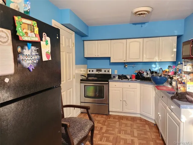 a kitchen with a refrigerator and a sink