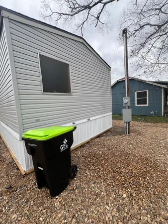 a view of a backyard with a small cabin and a chair