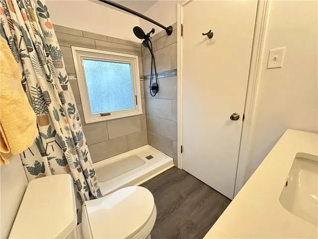 a bathroom with a sink toilet and a mirror