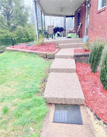 a bathroom with a granite countertop sink mirror vanity and toilet
