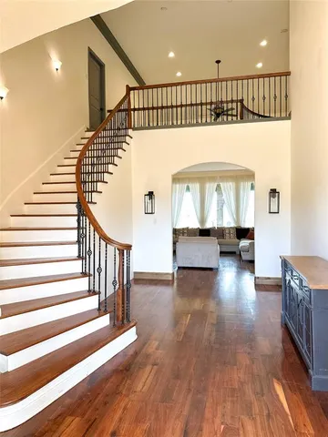 a view of entryway and hall with wooden floor