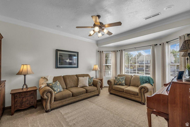 841 1010 S Street St. George, UT 84790 - Photo 4 of 33 Carpeted living room with crown molding, a textured ceiling, and a ceiling fan
