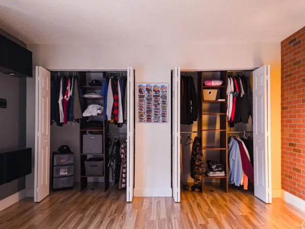 a view of walk in closet with clothes and shoes