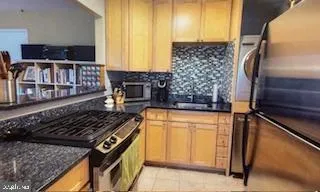 a kitchen with stainless steel appliances granite countertop a stove and a refrigerator