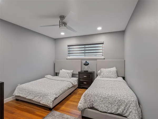 a bedroom with two beds and painted walls