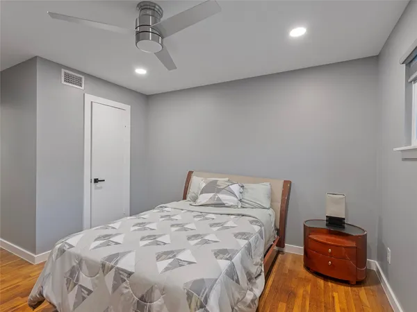a bedroom with a bed and a ceiling fan