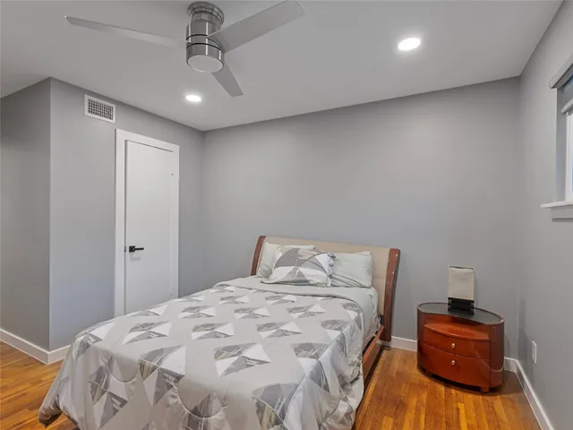 a bedroom with a bed and a ceiling fan