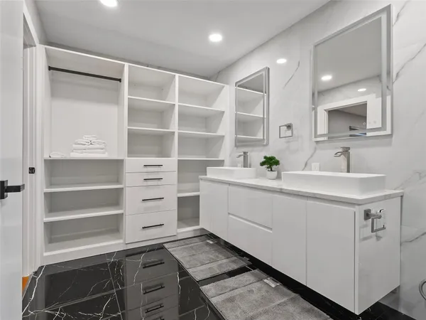 a spacious bathroom with a sink double vanity and a mirror