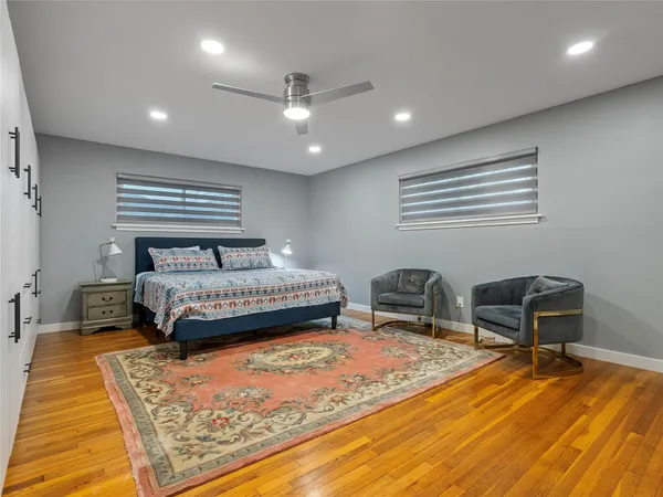 a bedroom with a bed and a chair