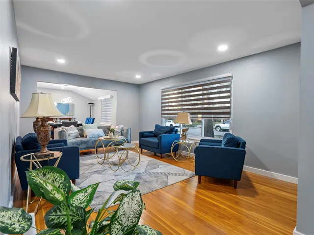 a living room with fireplace furniture and a window