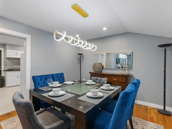 a view of a dining room with furniture and wooden floor