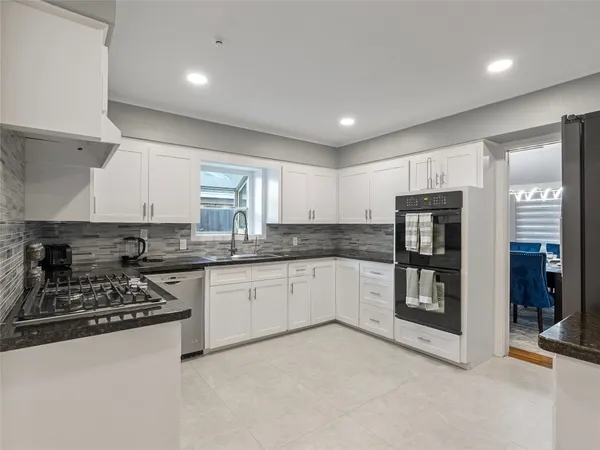 a kitchen with stainless steel appliances granite countertop a stove and a refrigerator