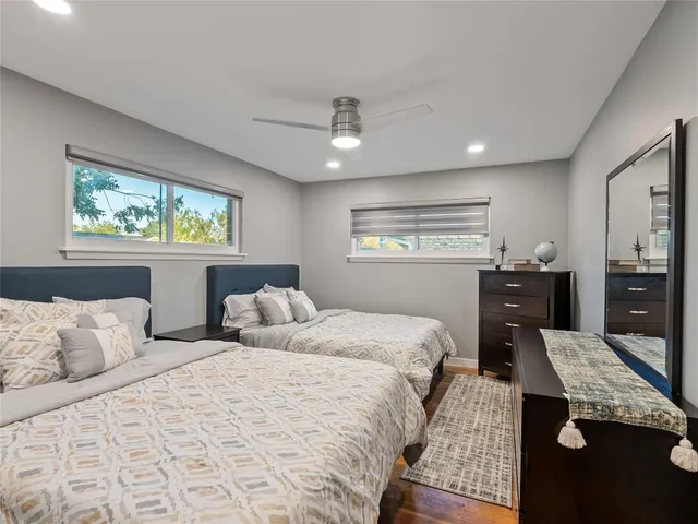 a bedroom with a bed window and dresser