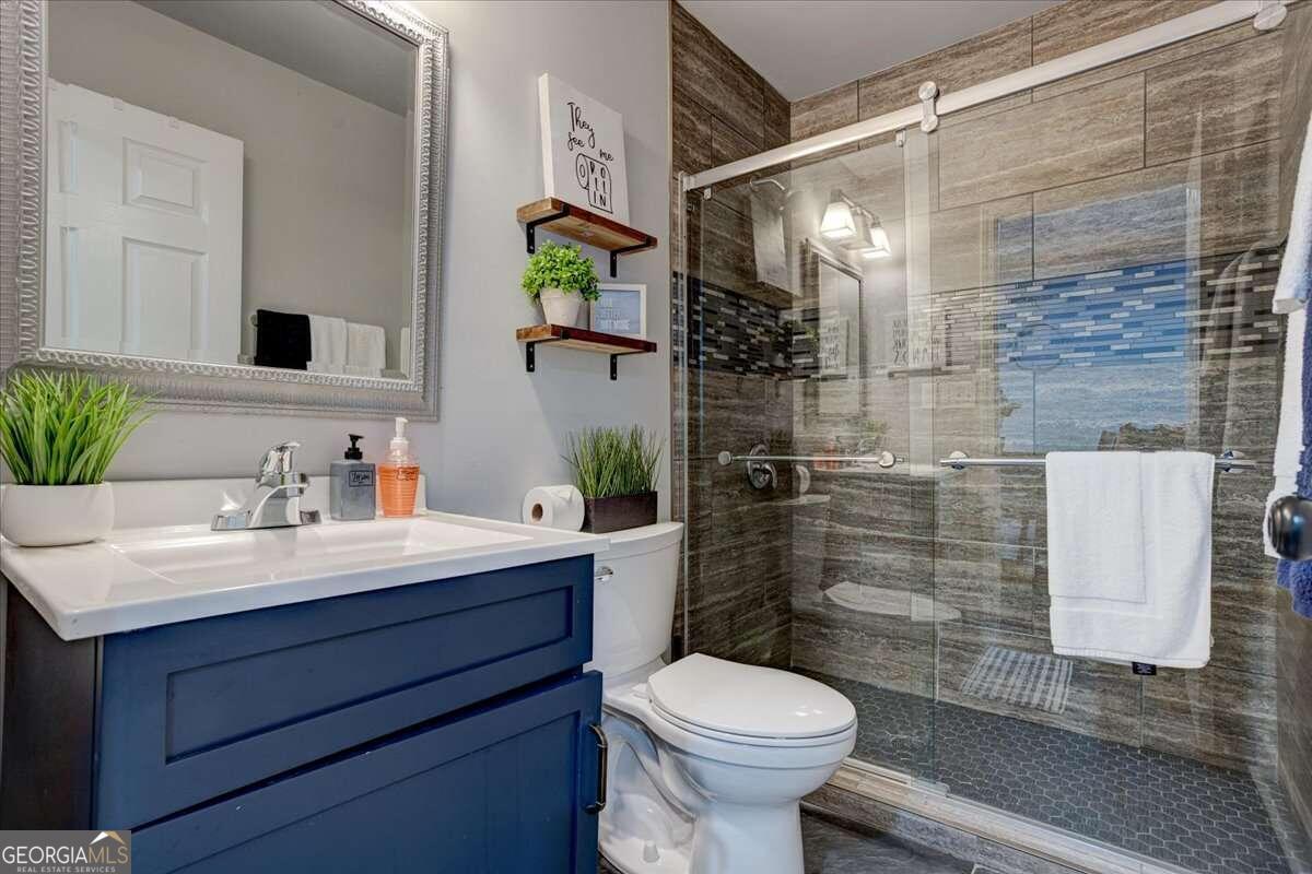 130 Mount Zion Road Southwest Atlanta, GA 30354 - Photo 3 of 7 a bathroom with a sink toilet and shower
