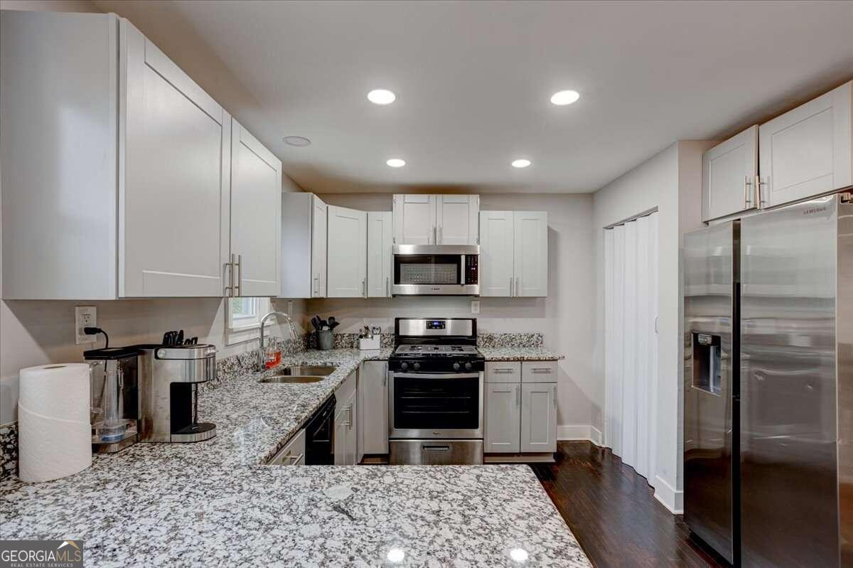 130 Mount Zion Road Southwest Atlanta, GA 30354 - Photo 5 of 7 a kitchen with stainless steel appliances granite countertop a refrigerator a stove a sink and a microwave