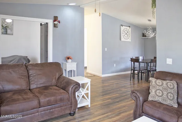 a living room with furniture and a dining table