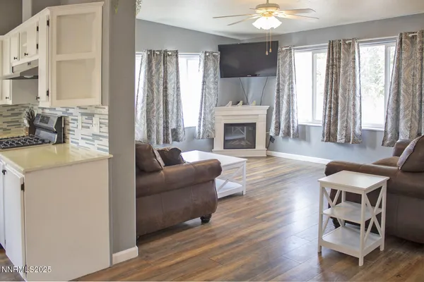 a living room with furniture a fireplace and a window