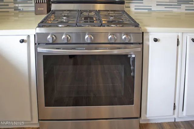 a stove top oven sitting inside of a kitchen