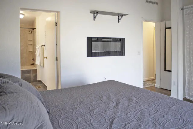 a bedroom with a bed and a painting on the wall