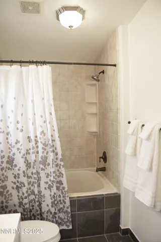a bathroom with a shower curtain and a sink