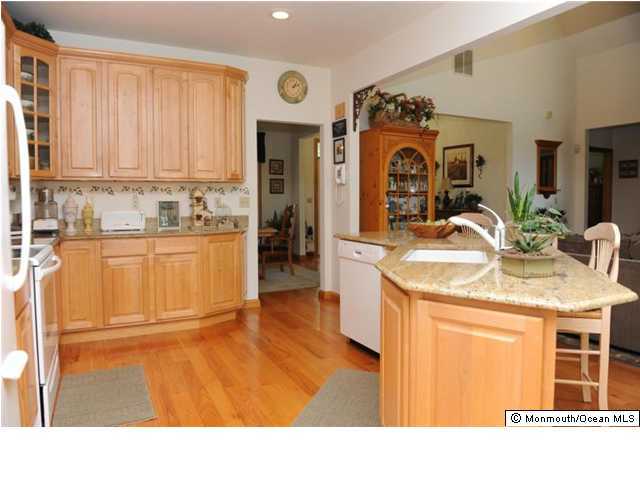 619 Reed Road Jackson, NJ 08527 - Photo 3 of 3 a kitchen with stainless steel appliances granite countertop a sink a stove and a refrigerator