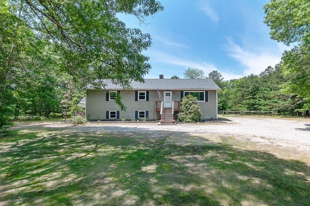 68 Bullock Road Freetown, MA 02717 - Photo 32 of 32 a front view of a house with a garden and trees