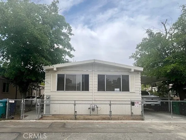 a house that has a tree in front of it