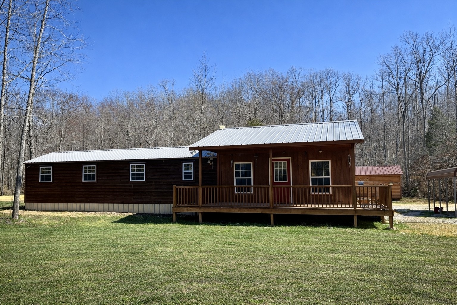 664 Russ Valley Road Lobelville, TN 37097 - Photo 4 of 63 a front view of a house with a yard