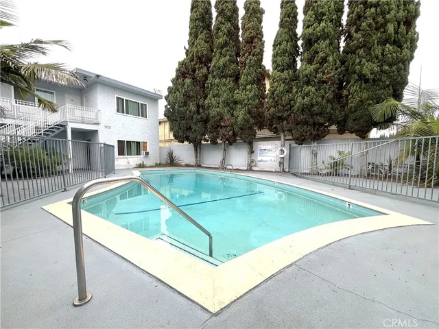 a view of a house with swimming pool and a yard