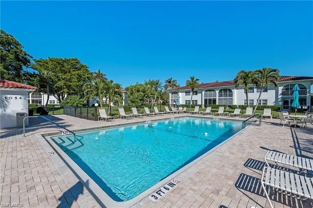 a view of a swimming pool and lounge chairs