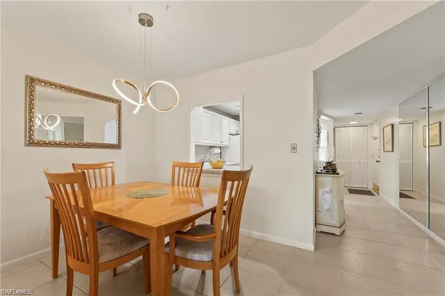 a view of a dining room with furniture and a chandelier