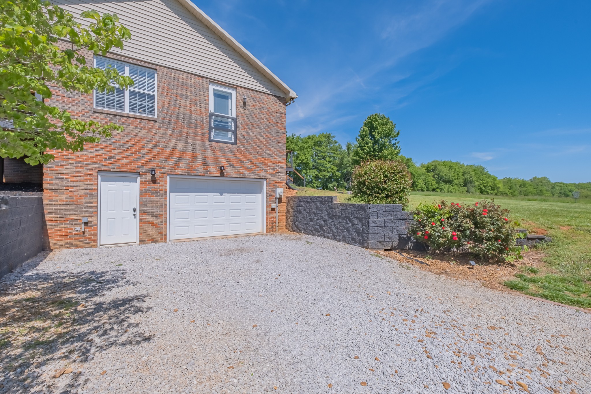 901 Spur Road Decherd, TN 37324 - Photo 56 of 59 a front view of a house with a yard and garage