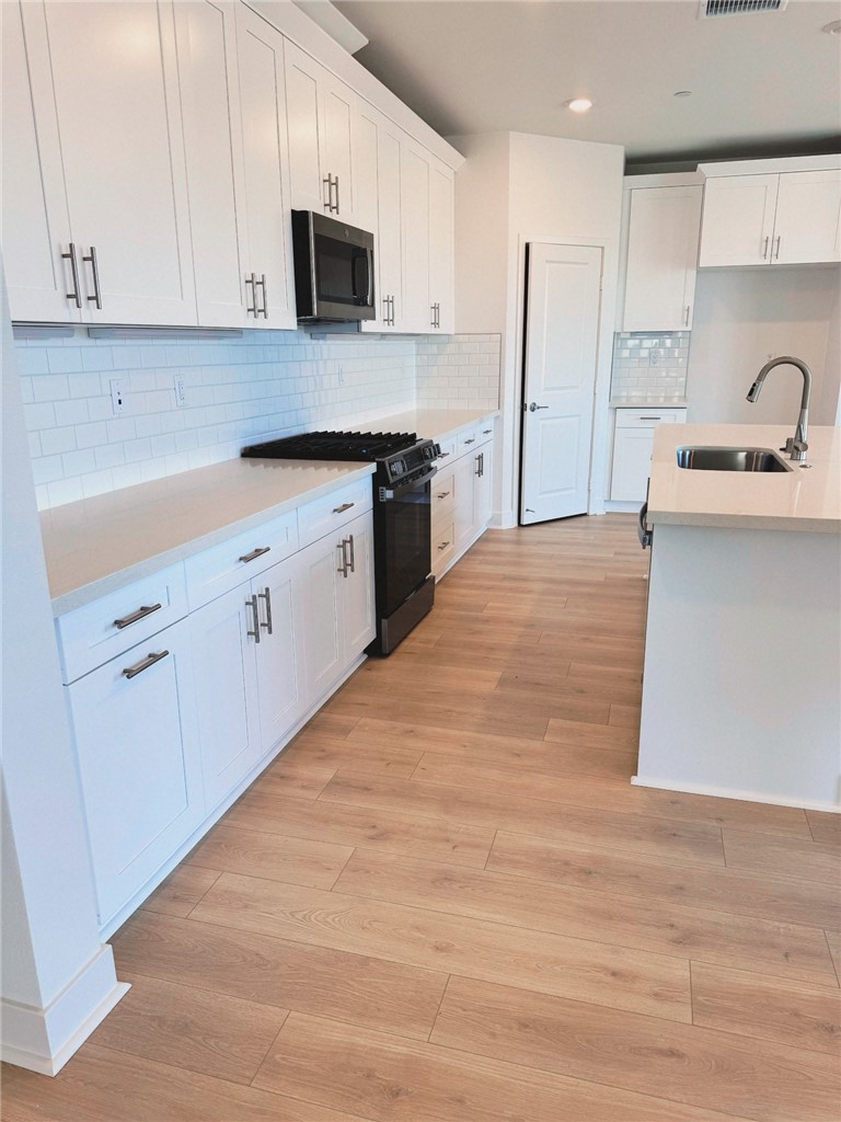 34291 Cyan Cove Winchester, CA 92596 - Photo 2 of 9 a kitchen with stainless steel appliances granite countertop a sink a stove and a refrigerator