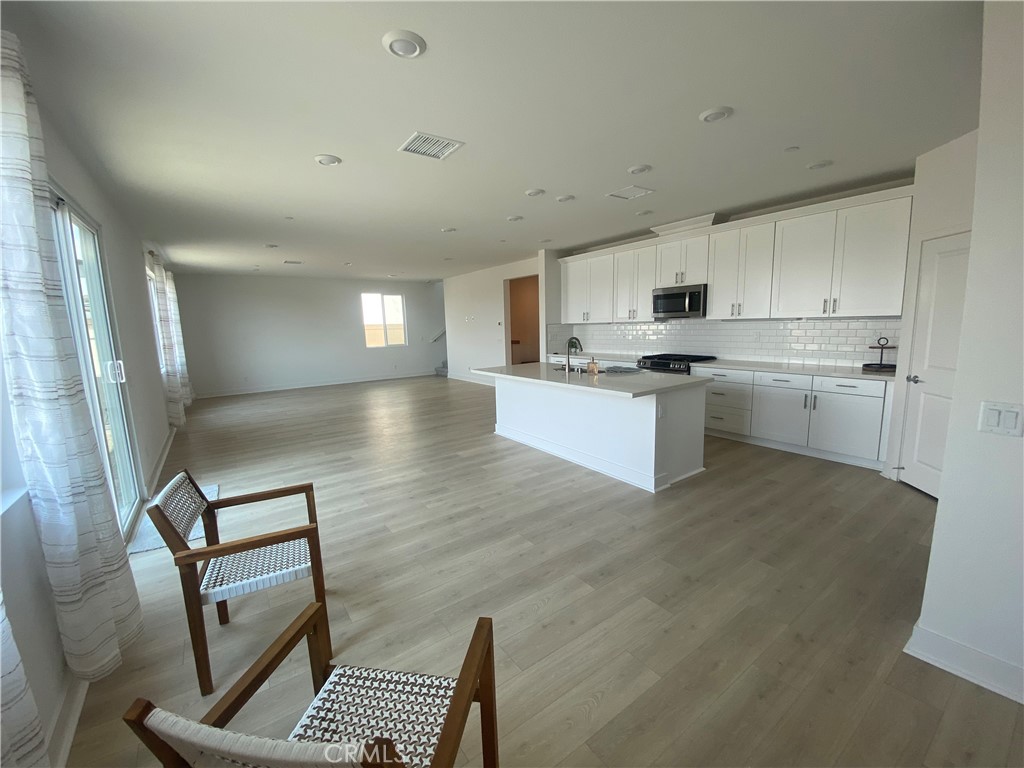 34291 Cyan Cove Winchester, CA 92596 - Photo 3 of 9 a kitchen with stainless steel appliances granite countertop a stove top oven a sink dishwasher and a refrigerator