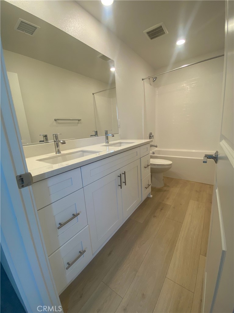 34291 Cyan Cove Winchester, CA 92596 - Photo 4 of 9 a bathroom with a double vanity sink mirror and toilet