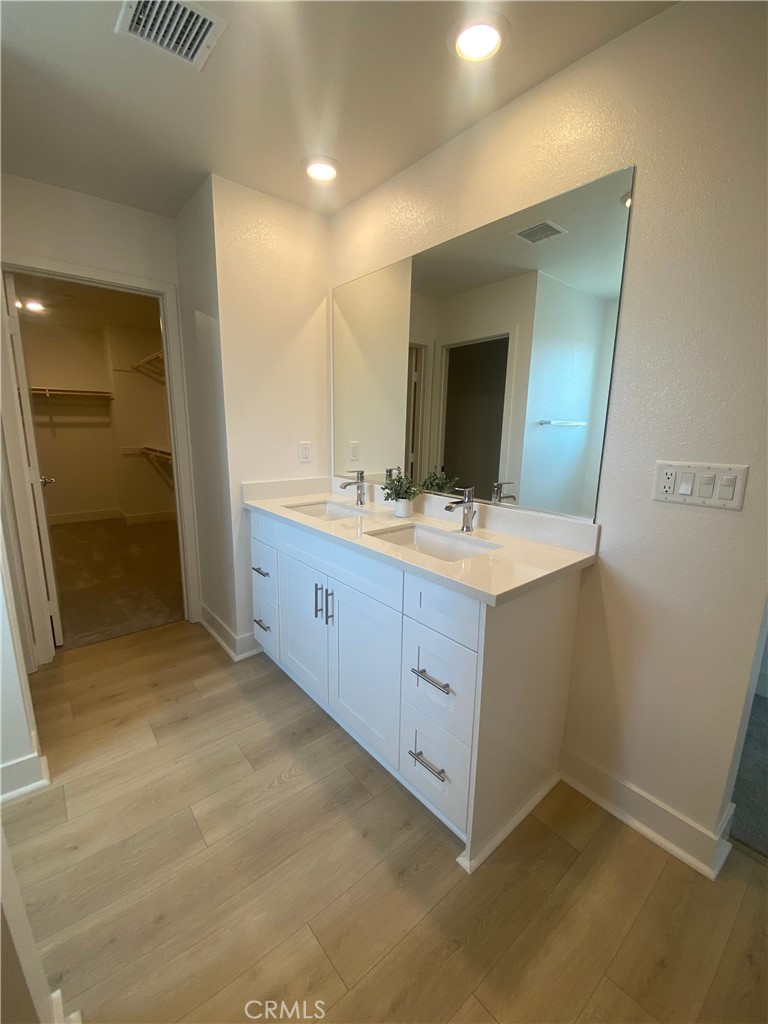 34291 Cyan Cove Winchester, CA 92596 - Photo 6 of 9 a room with a sink and a mirror