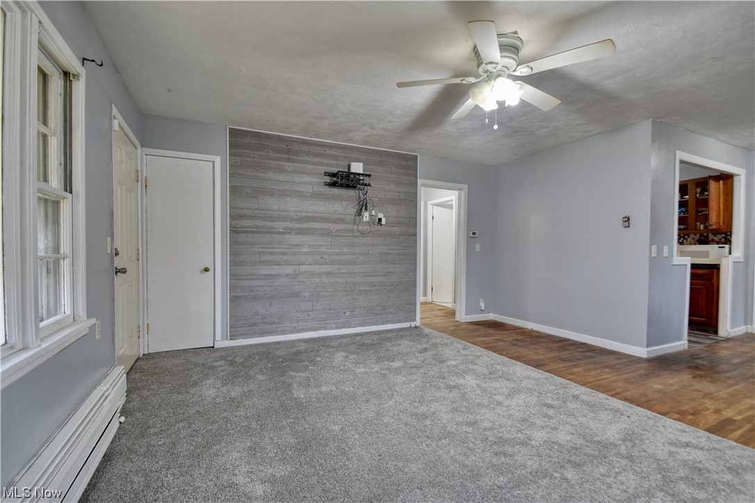 980 Reeve Road Elyria, OH 44035 - Photo 14 of 24 Carpeted spare room with ceiling fan and a baseboard radiator
