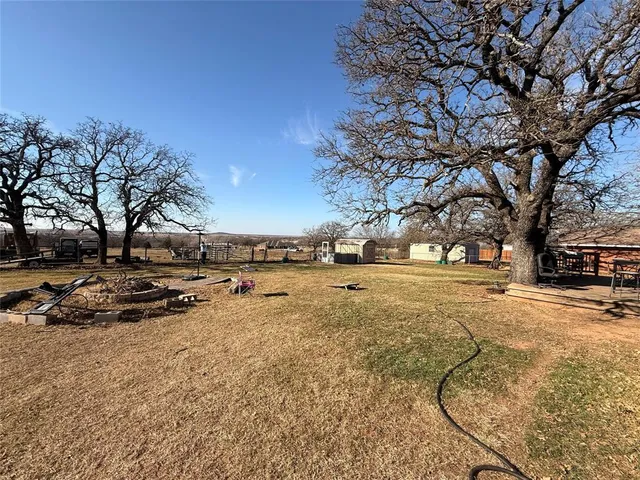 a view of yard covered with snow in front of house