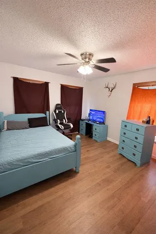 a bedroom with furniture and a flat screen tv