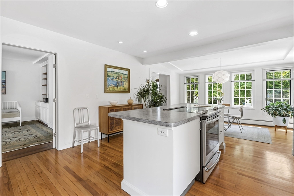 58 Front Street Northampton, MA 01053 - Photo 10 of 42 a kitchen with stainless steel appliances granite countertop a stove and a large countertops with wooden floor