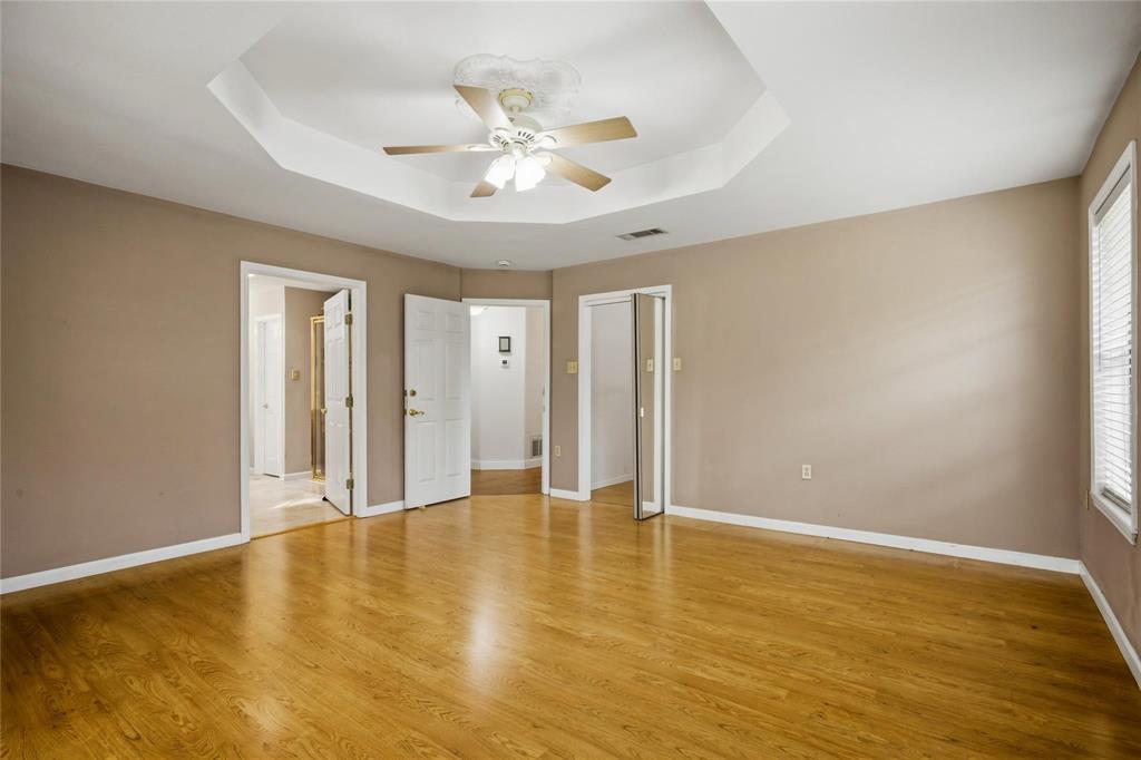 265 East Dove Road Southlake, TX 76092 - Photo 16 of 39 a view of an empty room with chandelier fan and wooden floor