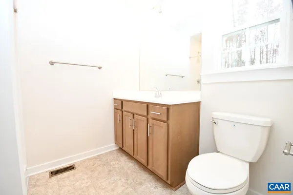 a white toilet sitting next to a bathroom sink