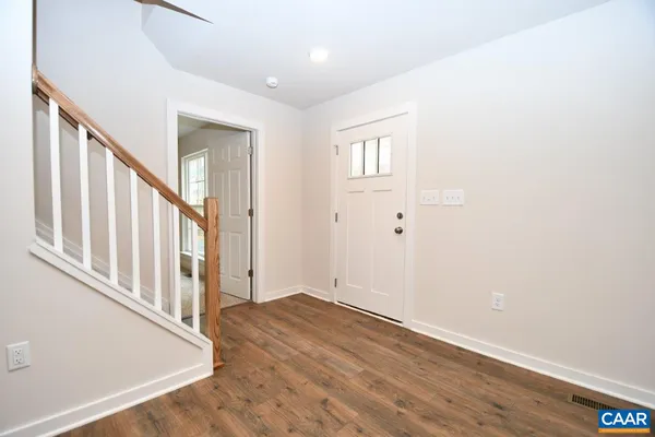 a view of an entryway with wooden floor