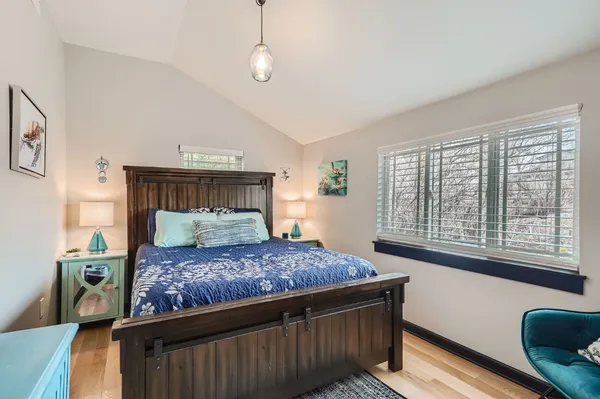 a bed sitting in a bedroom next to a window