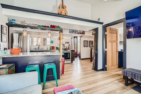 a living room with furniture and a wooden floor