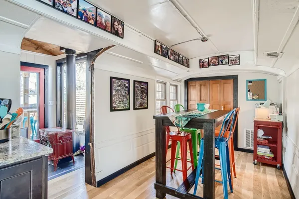 a view of an chairs and dining room with furniture window and wooden floor