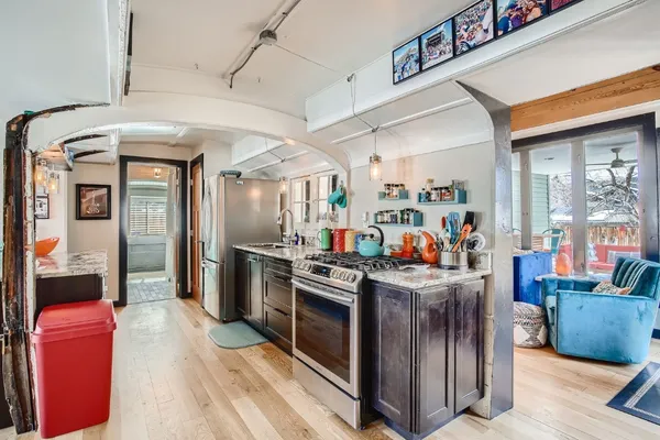 a kitchen with stainless steel appliances granite countertop a stove and cabinets